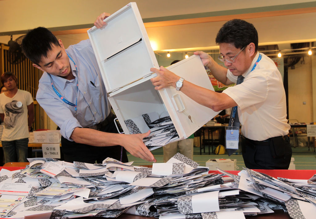 Election officials empty ballot boxes to count votes in Hong Kong (2011)