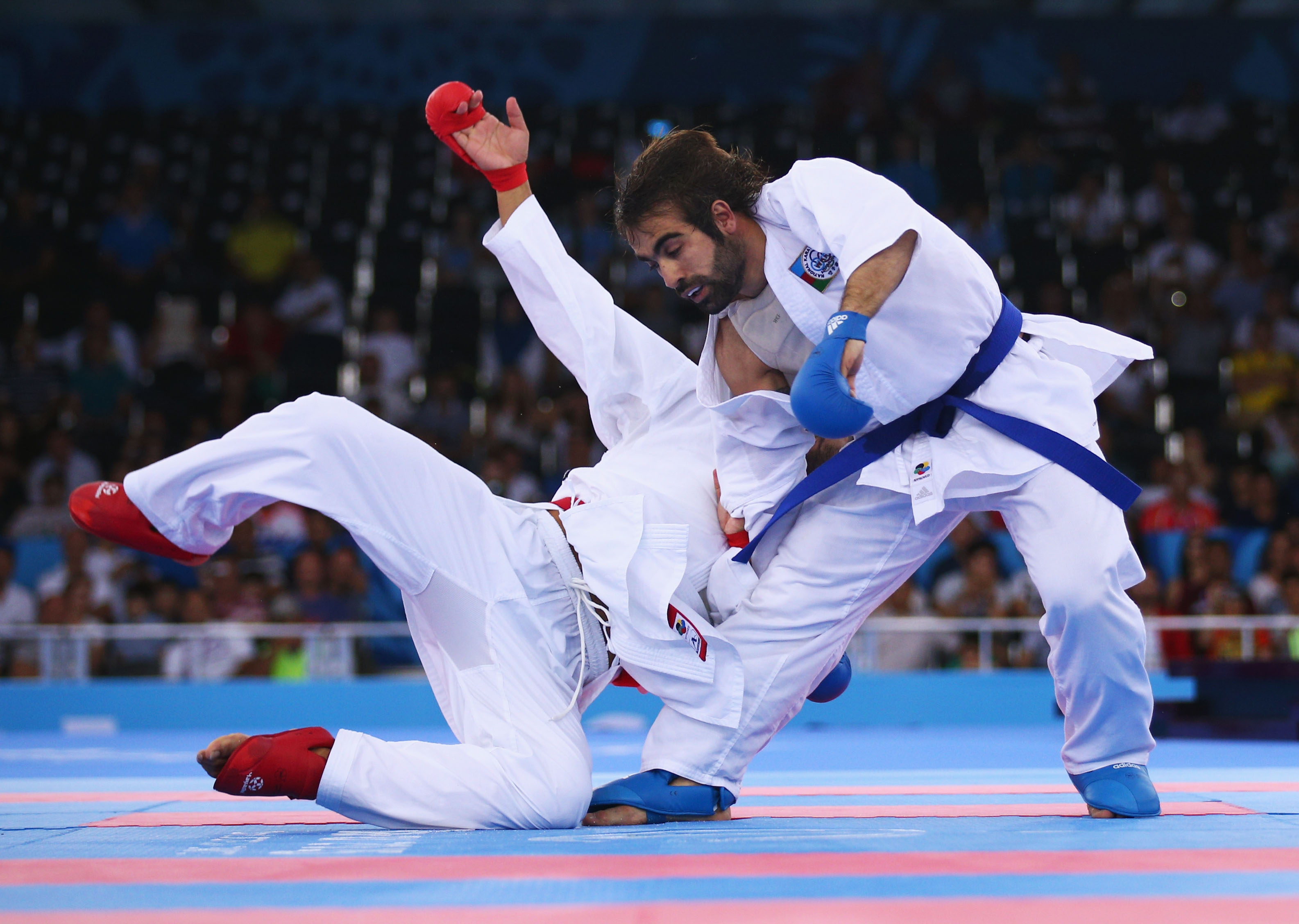 Rafael Aghayev from Azerbaijan (blue) takes on Luigi Busa from Italy (red) on the first day of the European Games in Baku 2015, 13 June 2015, during the final Kumite 75 kg men.