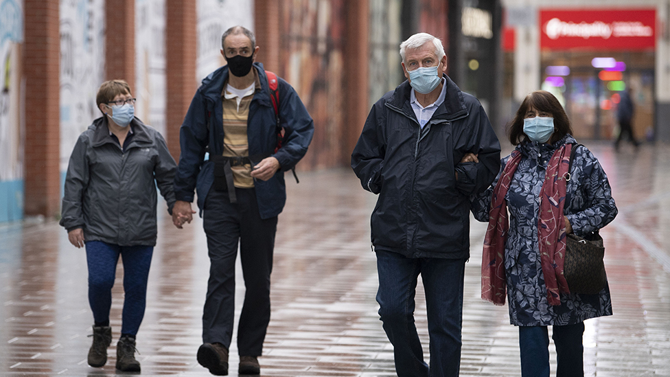 People walking with face coverings