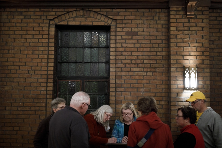 Caucus captains gather around a mock official 