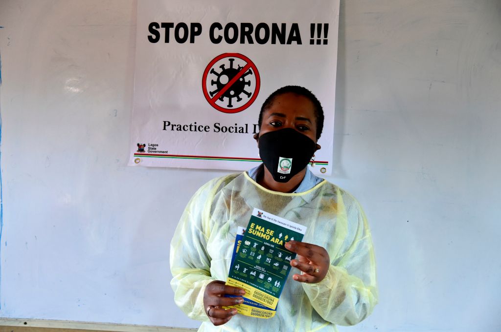 Woman holding coronavirus message pamphlet