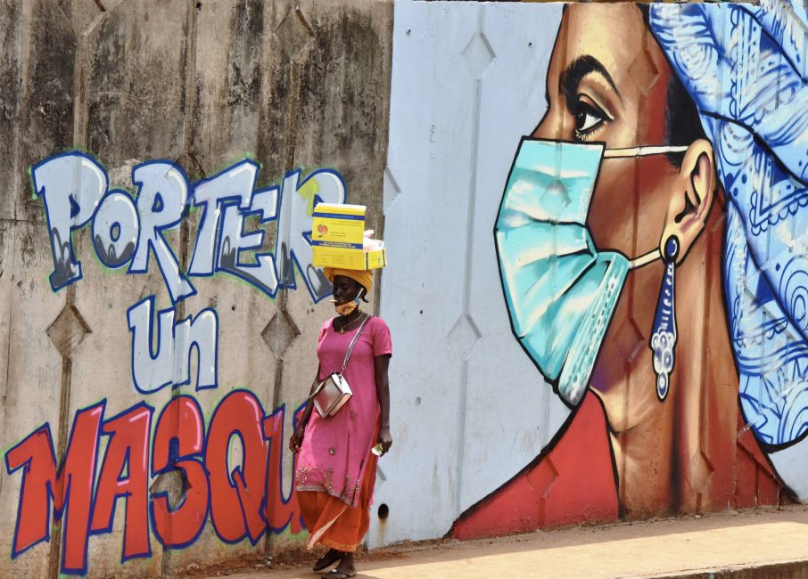 A mural of a woman wearing a face mask in Guinea