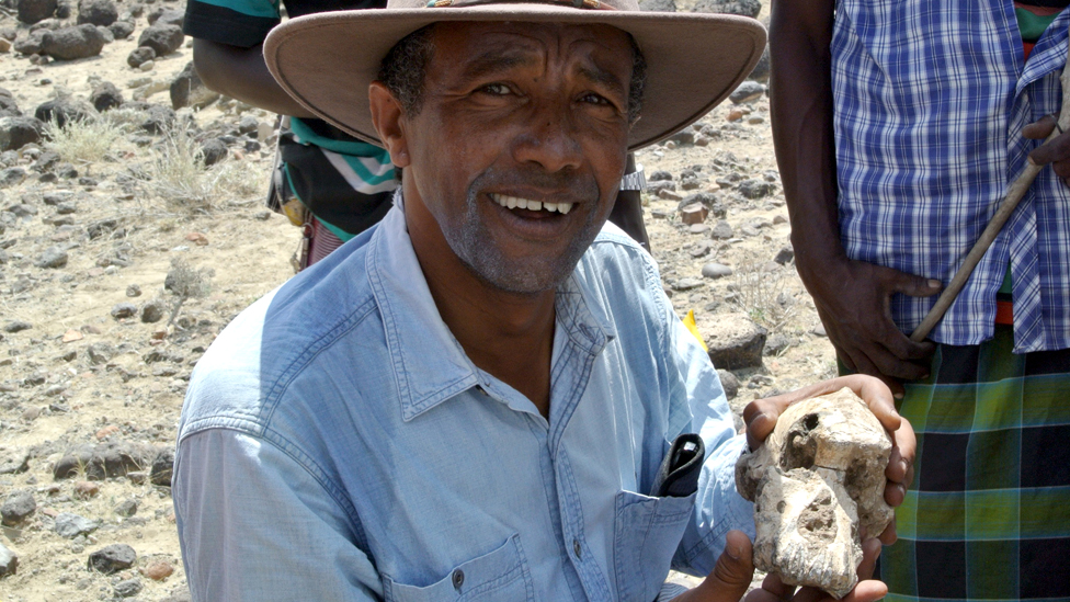Prof Yohannes Haile-Selassie holding the skull he found