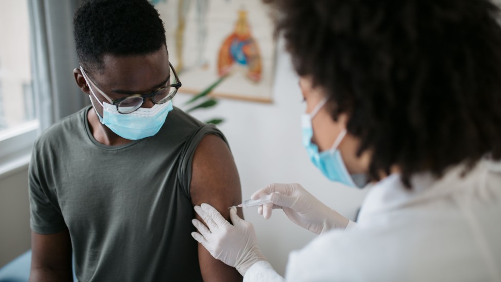 Black man being vaccinated