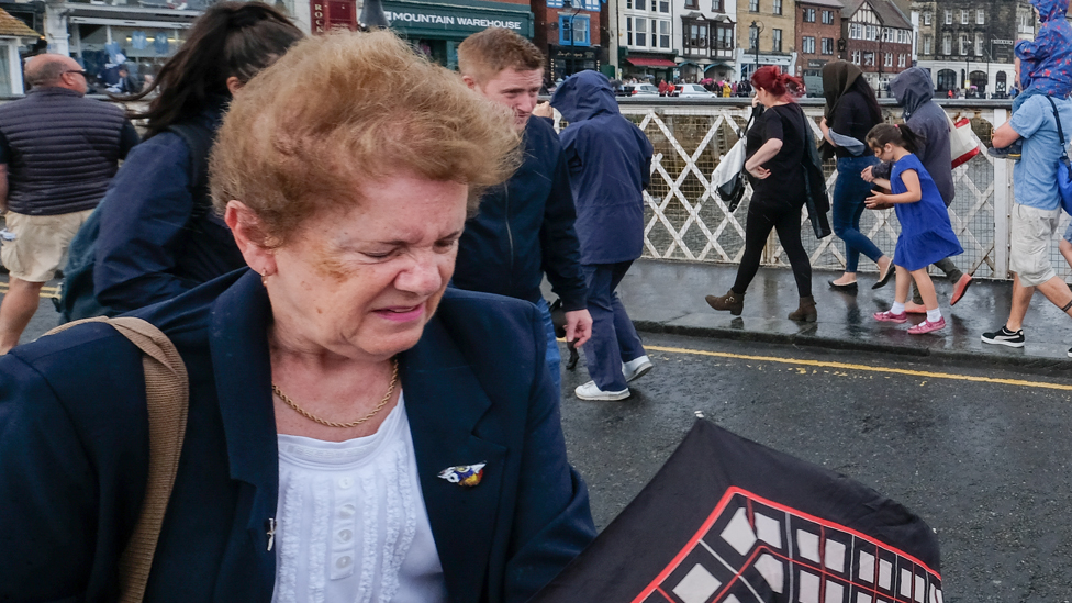 Visitors battle strong winds during a thunderstorm at the annual Whitby Regatta, August 2019