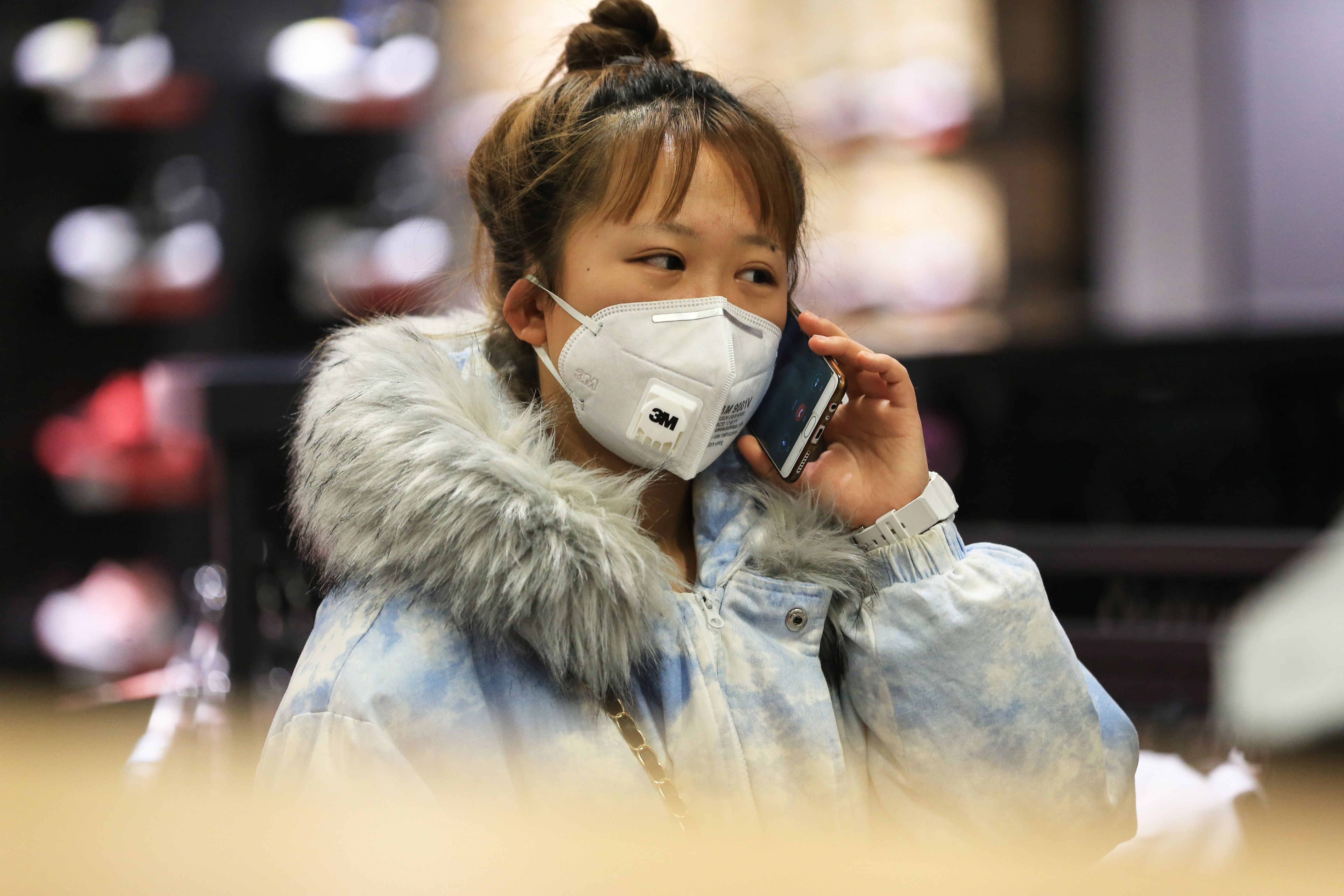 A Chinese woman in a shopping mall in Shenyang wears a face mask.