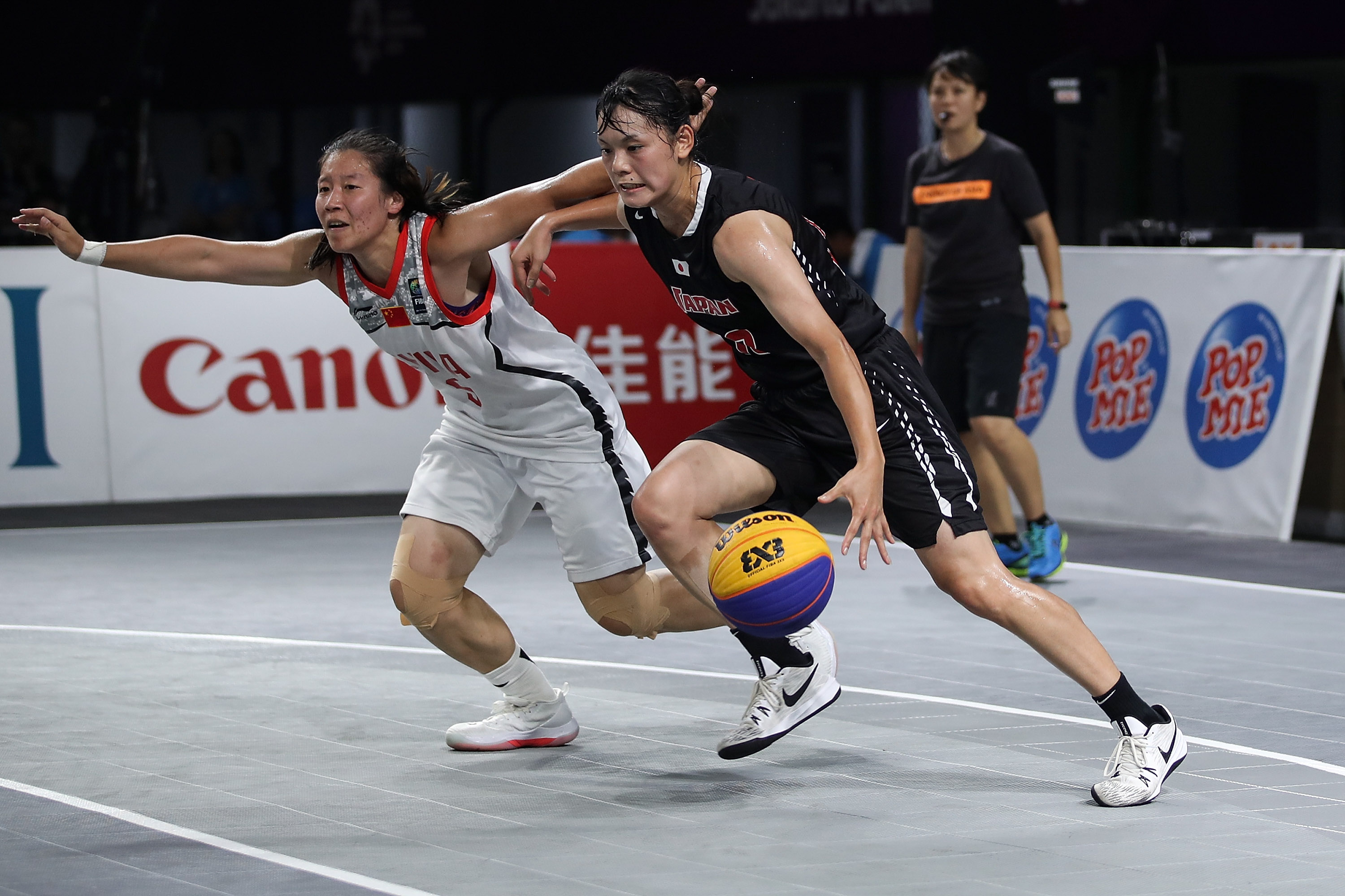 Li Yingyun from China and Okuyama Ririka from Japan in action during Women's Basketball 3X3 final between China and Japan during the Asian Games on August 26, 2018 in Jakarta, Indonesia.