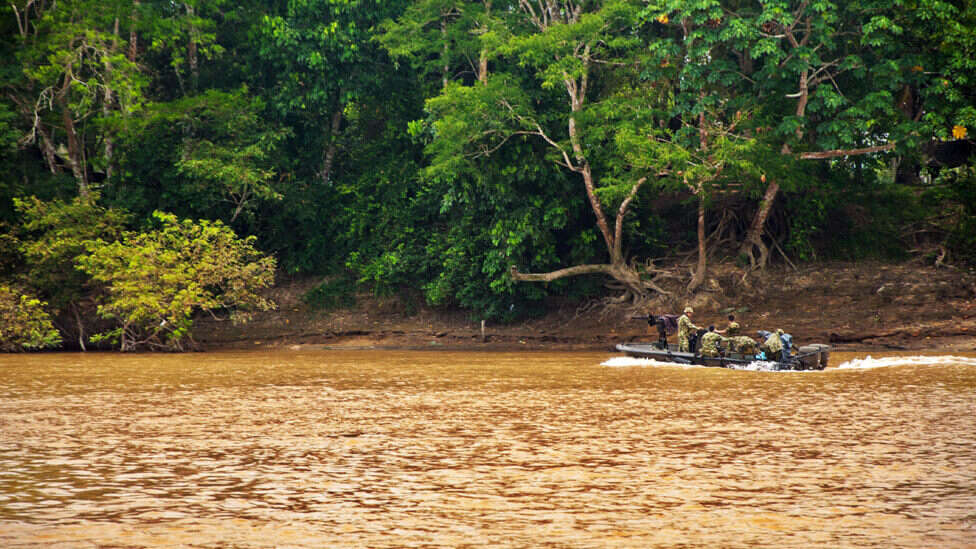 Colombian soldiers patrol the Guayabero River, near La Macarena, in 2010