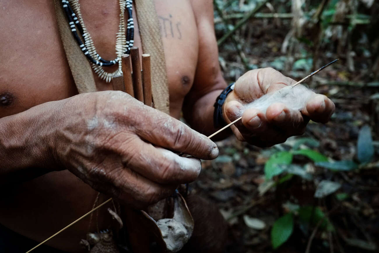 Indigenous hunter in the Amazon using a weapon