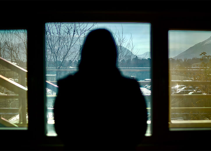Photo of Ameena looking out of a window