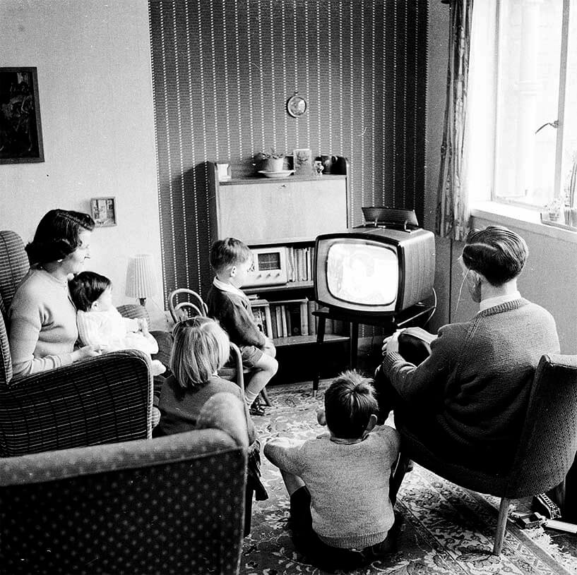People watching a 1950s TV at home