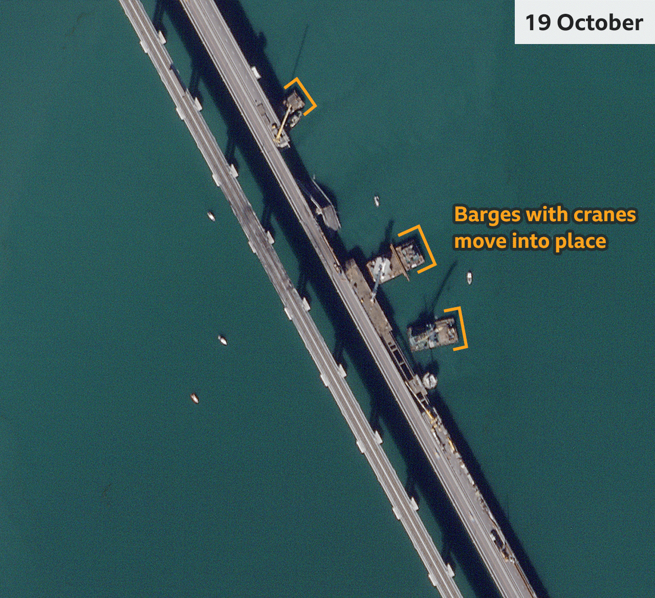 On 19 October, three barges carrying cranes can be seen floating near the damaged bridge sections