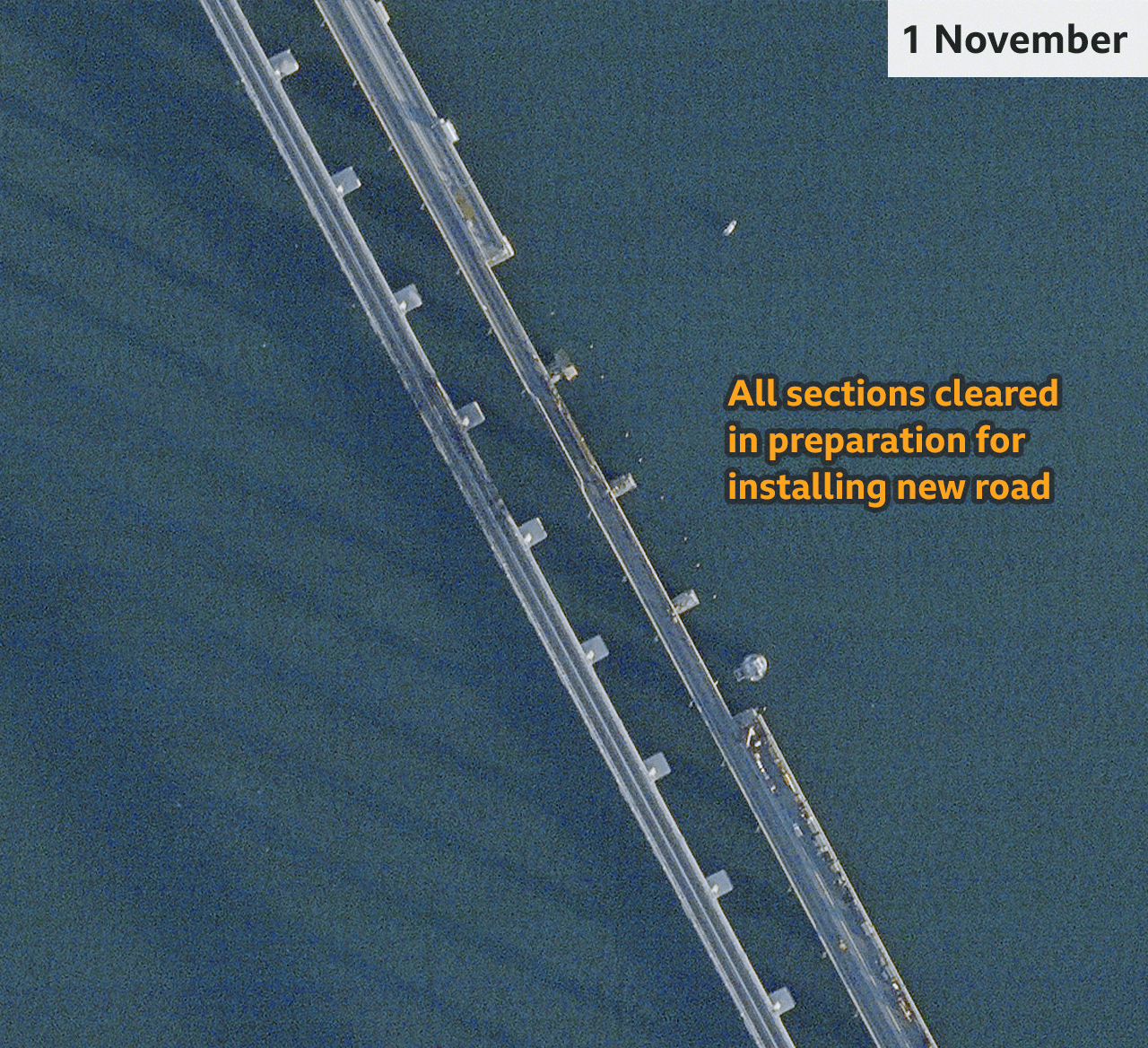 An image from 28 October show some damaged sections having been removed. The cranes appear to be loading more damaged road pieces onto barges.
