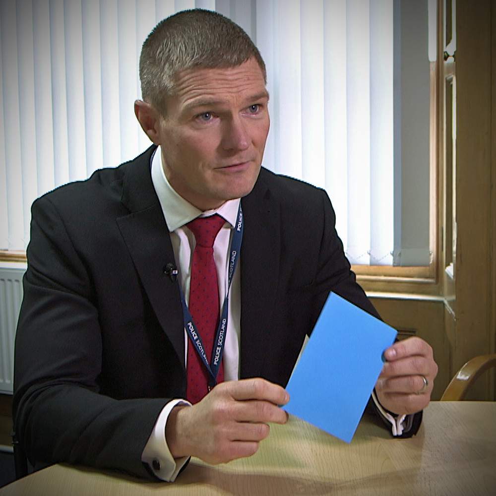 Det Supt Gary Cunningham, of Police Scotland&#39;s Major Investigation Team, holds an envelope similar to the one handed to Alistair Wilson&amp;nbsp;