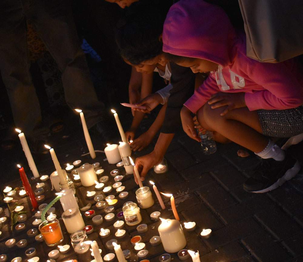 Children light candles