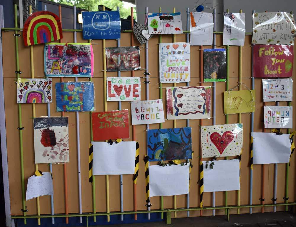 Posters on the railings near Grenfell