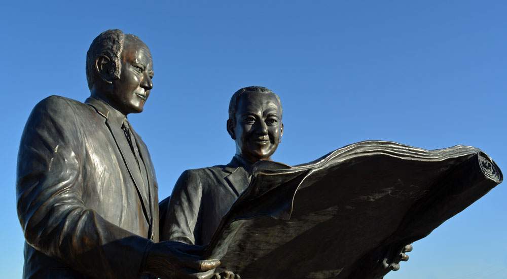 A statue of McCulloch and Wood stands at one end of the bridge