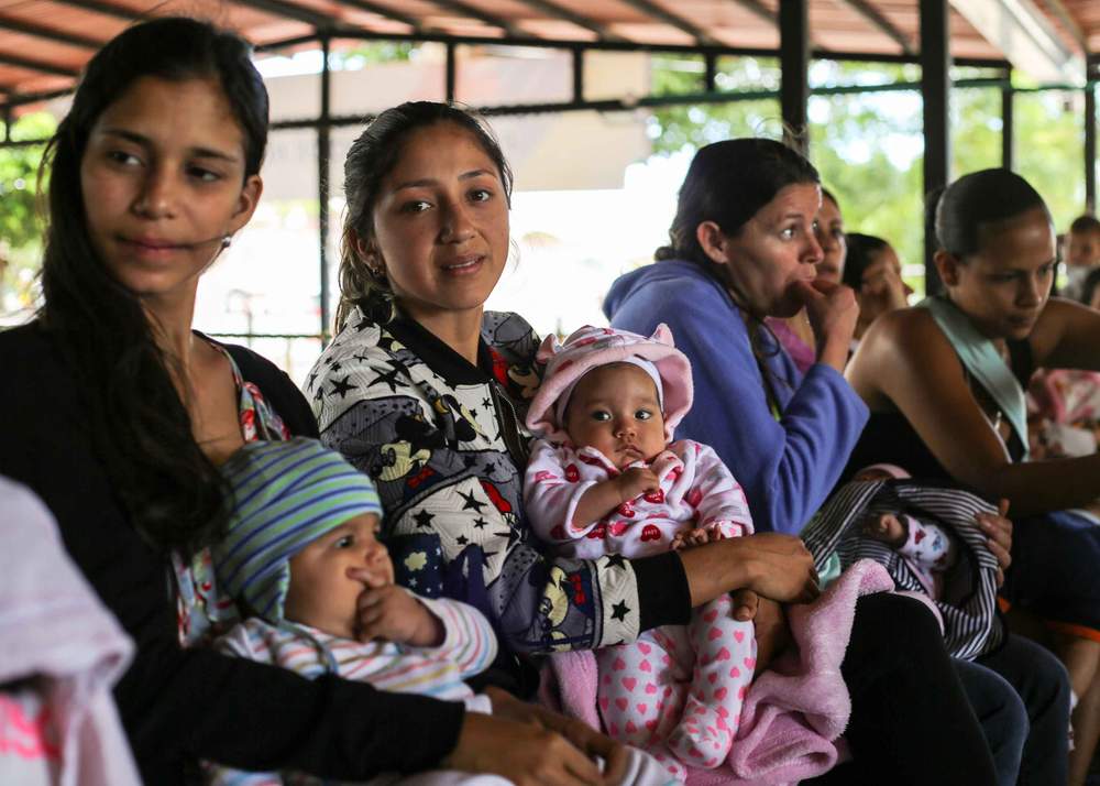 Celene Cacique (second left) and her baby Isabella