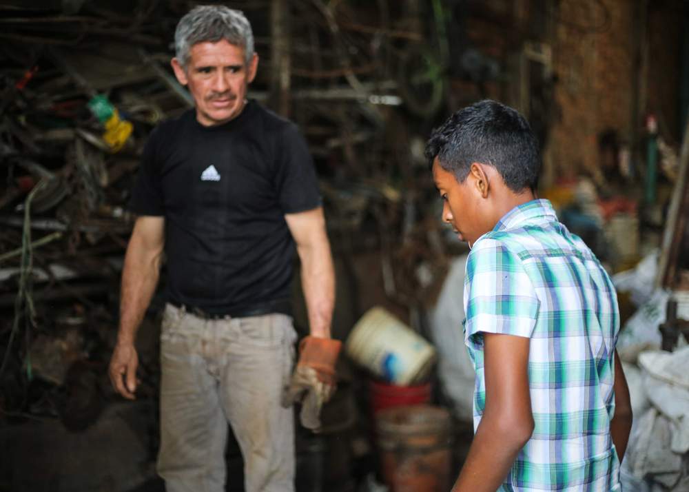 Scrap metal dealer Pompilio Rincón with young collector Breiner Hernández&amp;nbsp;