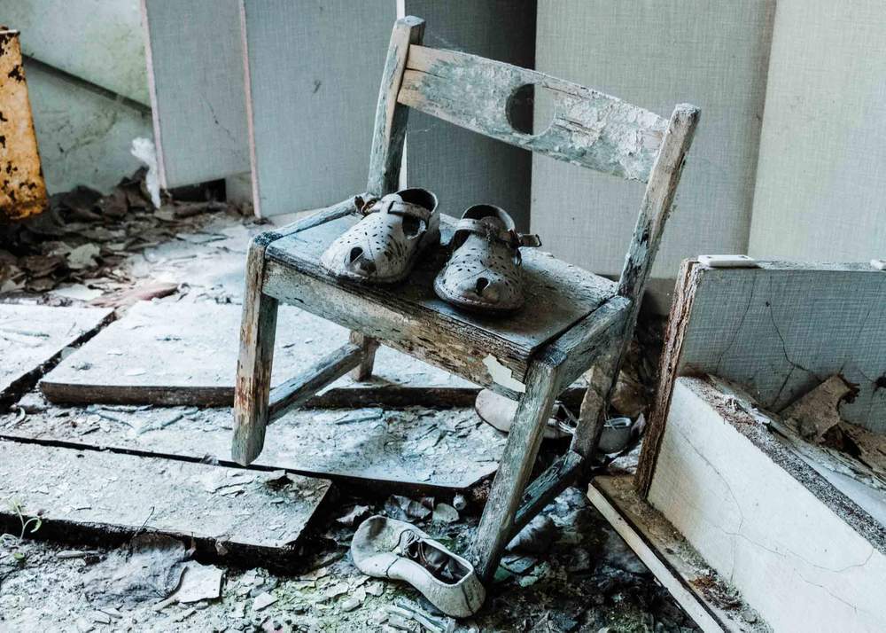 A child&#39;s shoes left behind in an abandoned nursery in the city of Pripyat