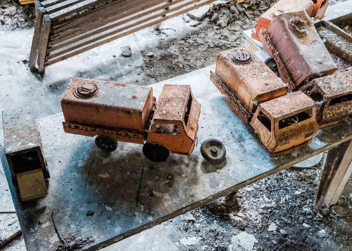 Toy trucks left behind in an abandoned nursery