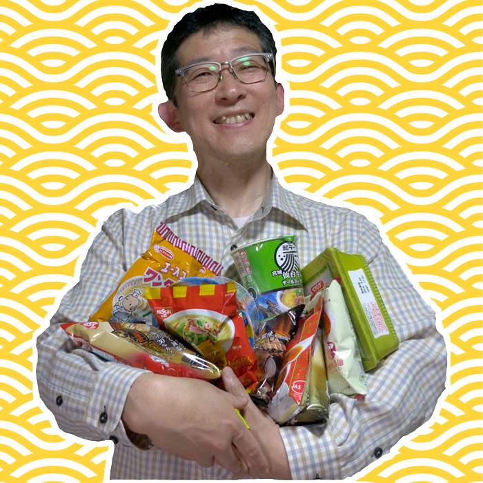 Toshio Yamamoto holding a few examples from his noodle collection