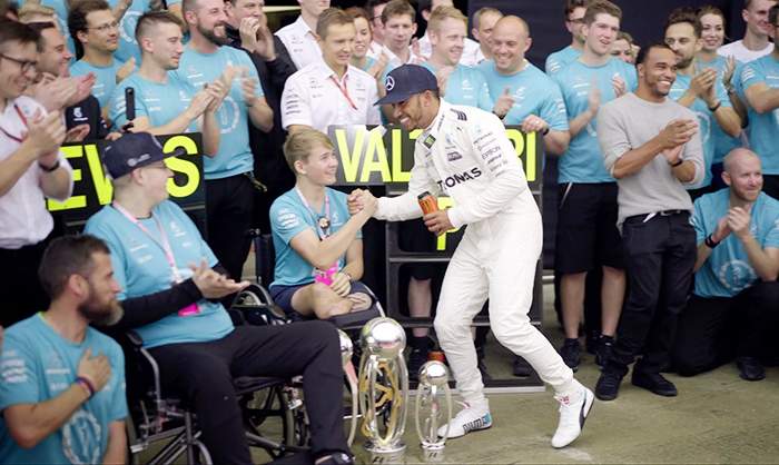 Billy celebrating with Lewis Hamilton at Silverstone