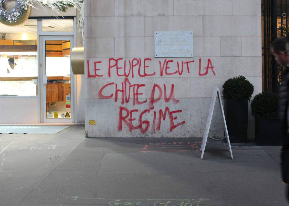 Graffiti reads: &quot;The people want the fall of the regime&quot;