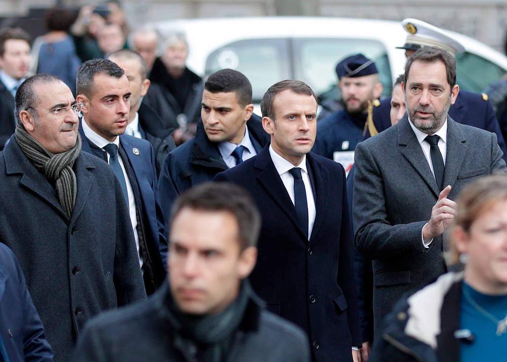 French President Emmanuel Macron (C) in Paris