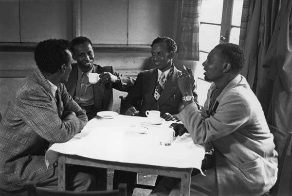 A group of Somalis meet for a drink and a smoke at a cafe in Tiger Bay, 1950