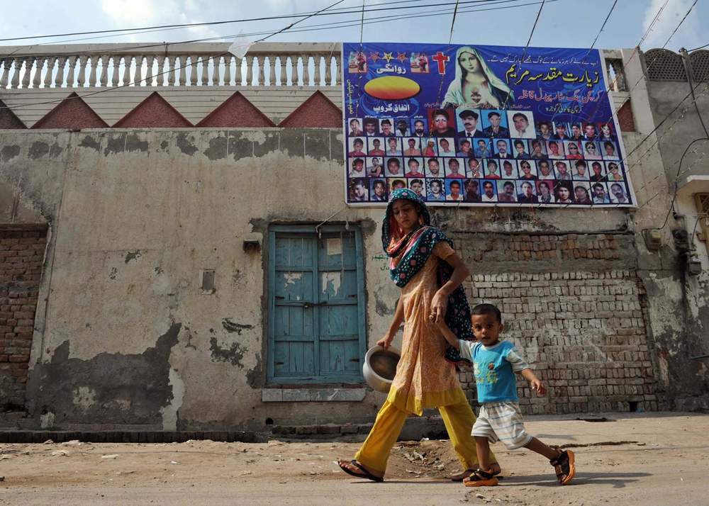 A woman walks with her child in Gojra&amp;nbsp;