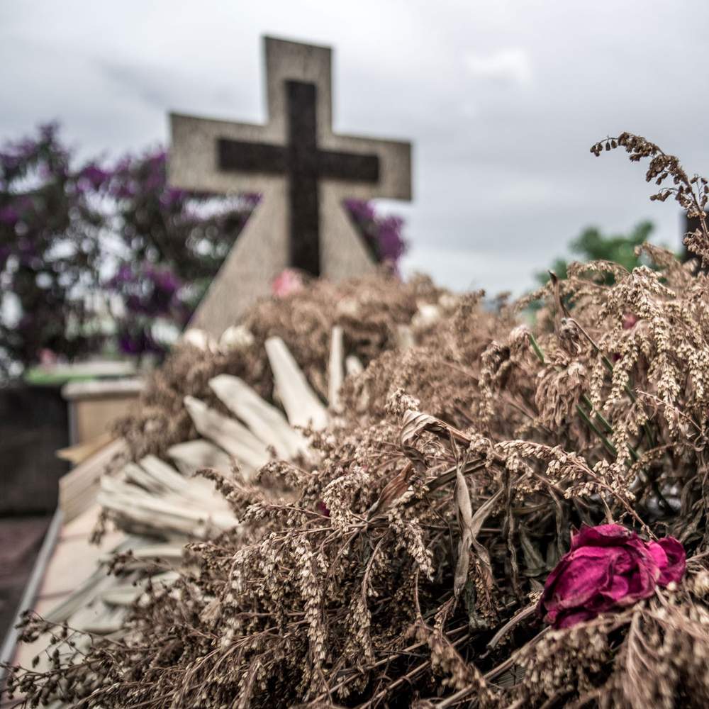 Dozens of matching funeral wreaths are visible across the city, all paid for by the company that owns the mine