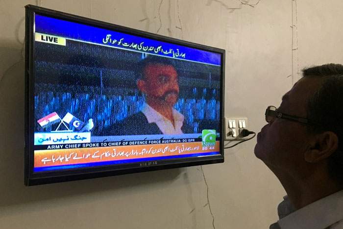 A man watches the televised release of Indian Wing Cdr Abhinandan&amp;nbsp;