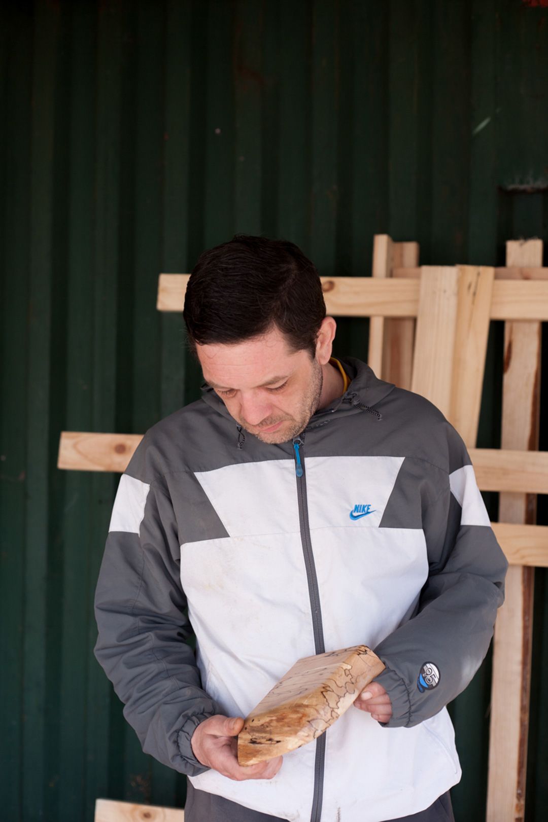 Joe Coughlan holding a piece of wood