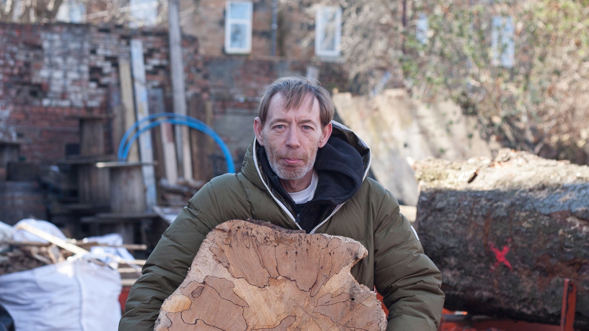 Man holding a piece of wood