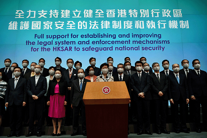 China's Hong Kong Chief Executive Carrie Lam Cheng Yuet-ngor (front center) led officials to meet with reporters to support Beijing's drafting of the Hong Kong National Security Law